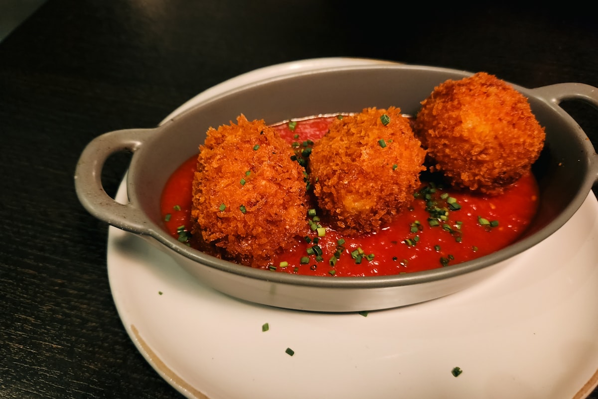 Crispy arancini with tomato sauce are delightful